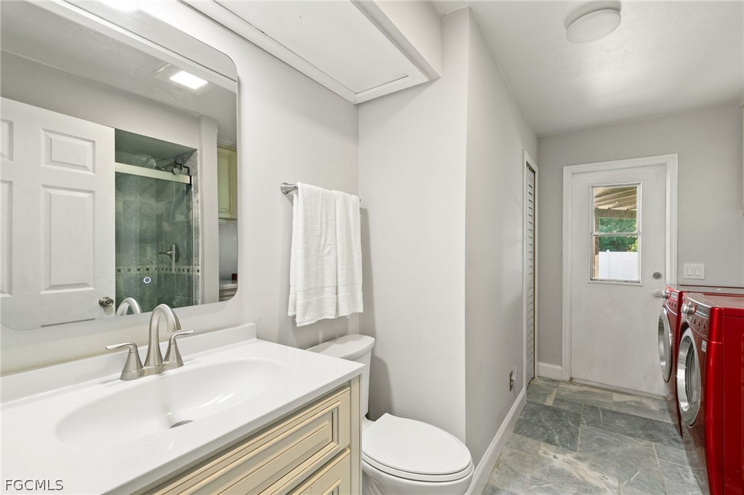 317 3rd Avenue Marco Island, FL 34145 - Photo 20 of 29 a bathroom with a sink a toilet a mirror and shower