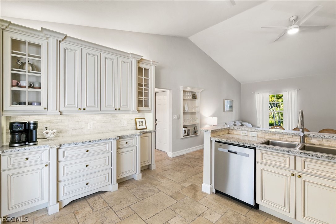 317 3rd Avenue Marco Island, FL 34145 - Photo 10 of 29 a kitchen with granite countertop white cabinets and white appliances
