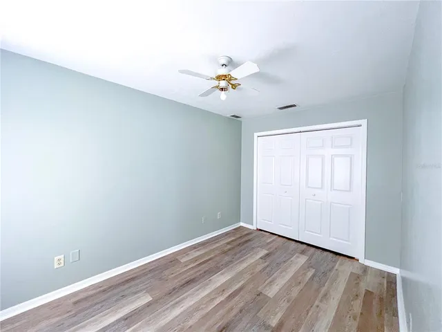 a kitchen with granite countertop a stove cabinets and wooden floor
