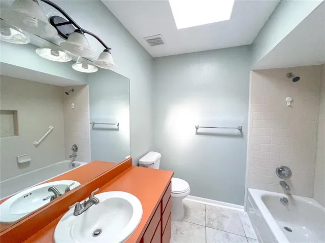 a view of empty room with window and ceiling fan