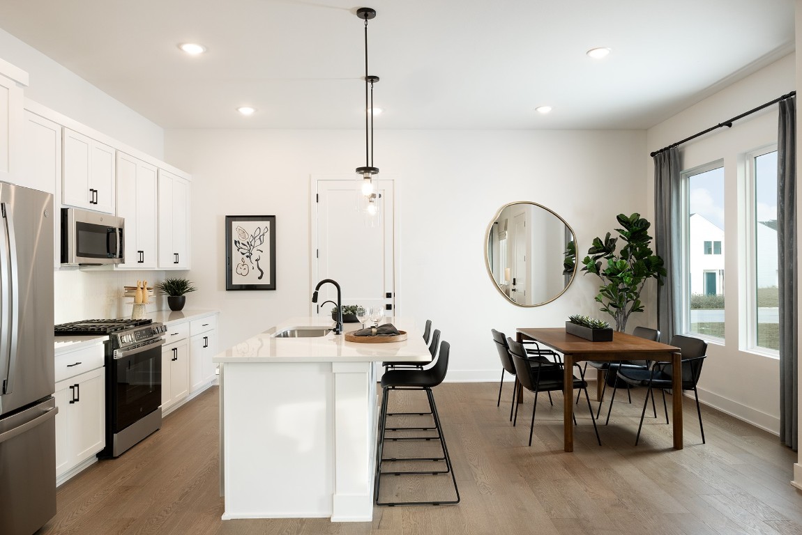 1310 Sweet Bark Street Austin, TX 78745 - Photo 6 of 13 a view of a dining room with furniture window and wooden floor