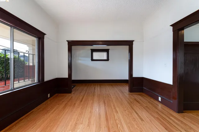 a view of a room with wooden floor and a window