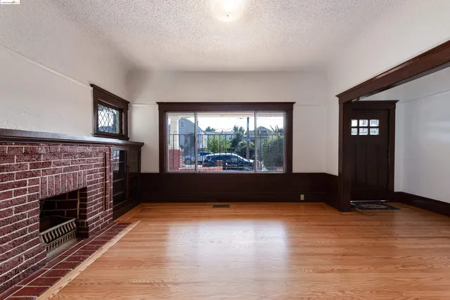 a living room with a fireplace and a floor to ceiling window