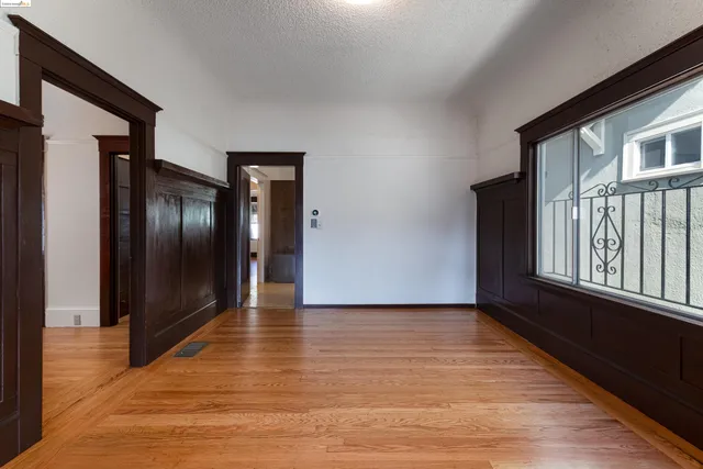 a view of a hallway with wooden floor and stairs