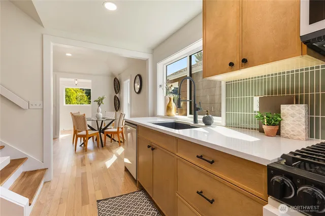 a kitchen with stainless steel appliances granite countertop a stove and a sink