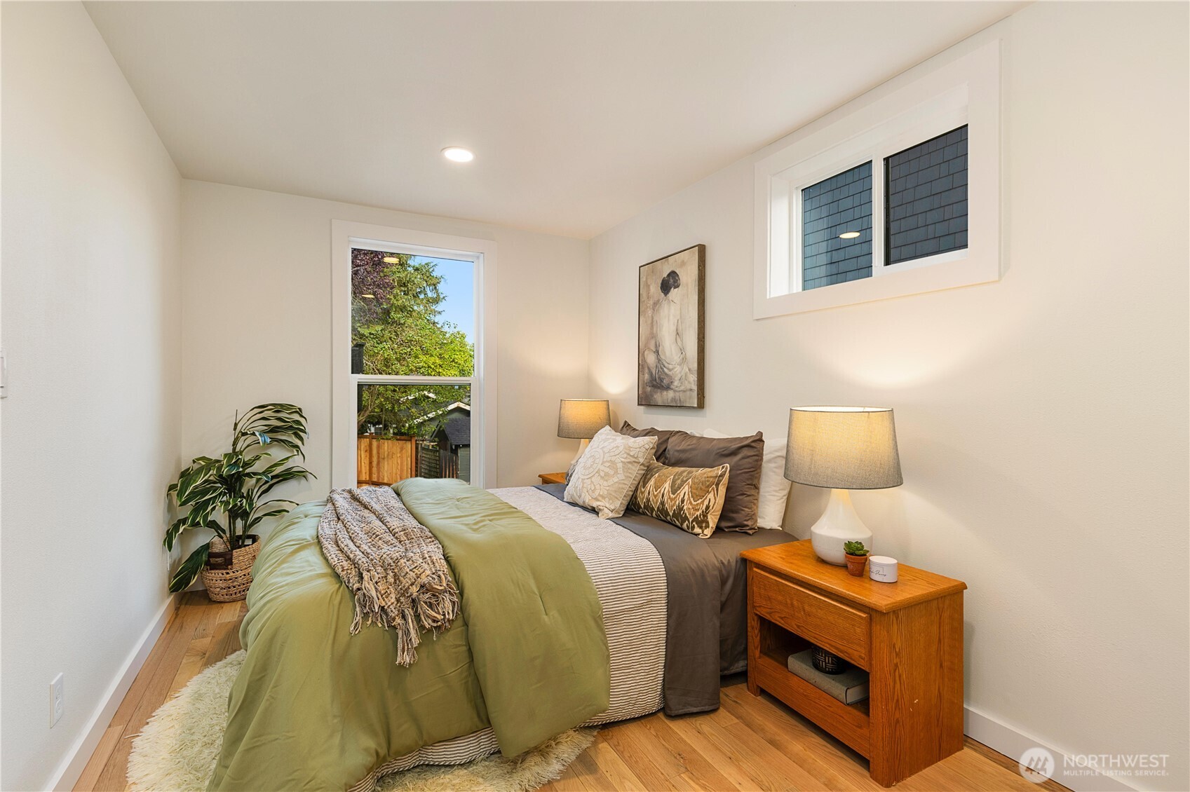 6031 McKinley Place North Seattle, WA 98103 - Photo 21 of 40 a bed room with a bed and a night stand