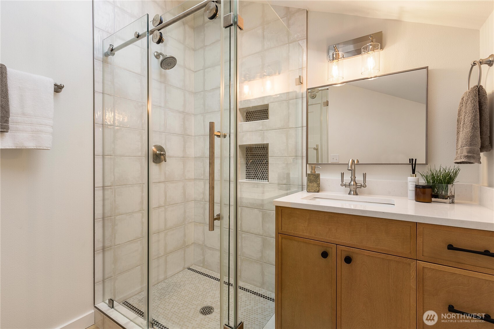6031 McKinley Place North Seattle, WA 98103 - Photo 26 of 40 a bathroom with a shower sink and mirror