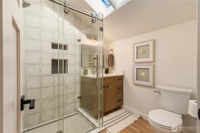 a bathroom with a toilet a sink and shower