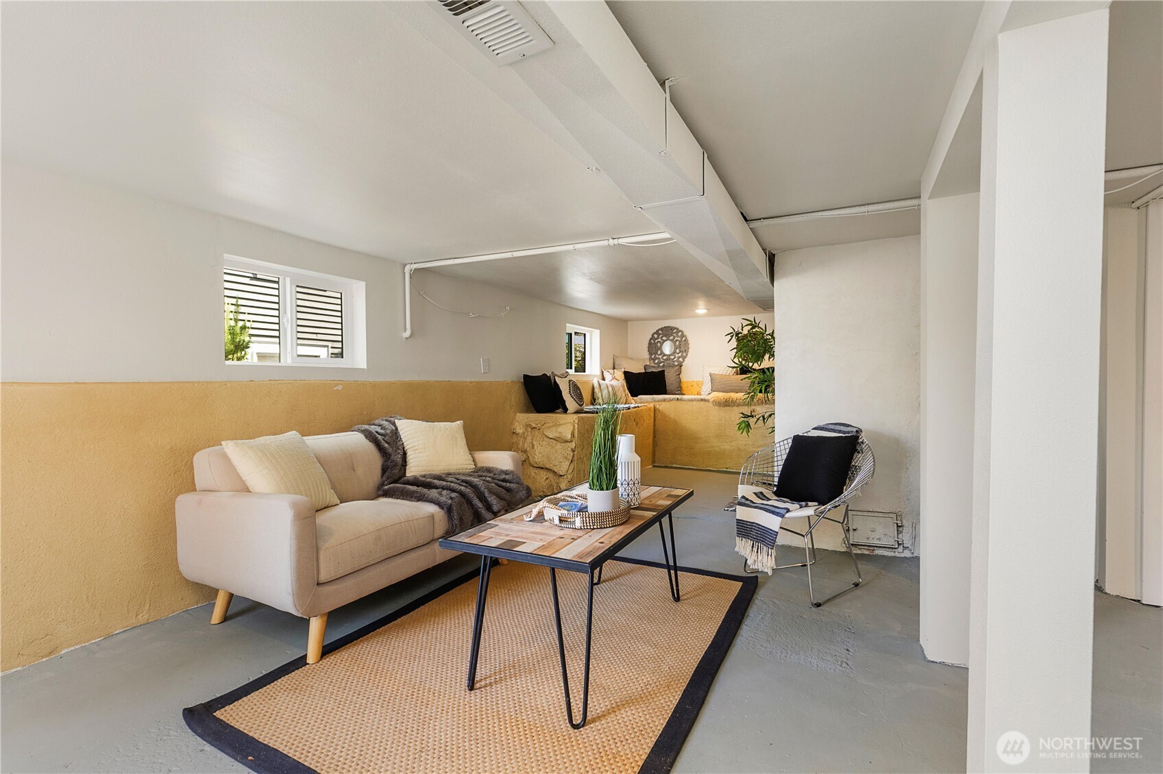 6031 McKinley Place North Seattle, WA 98103 - Photo 35 of 40 a living room with furniture a rug and a window