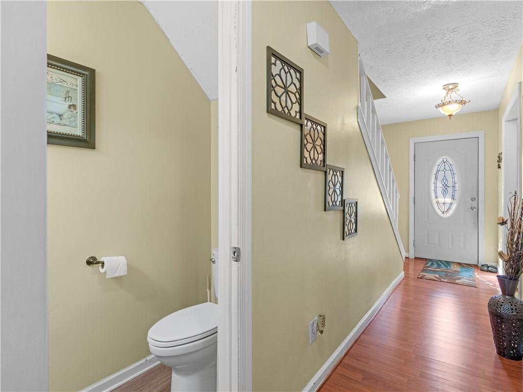 103 Oak Circle South Stockbridge, GA 30281 - Photo 3 of 11 a bathroom with a toilet and a wooden floor