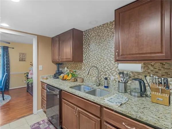 a kitchen with sink cabinets and wooden floor