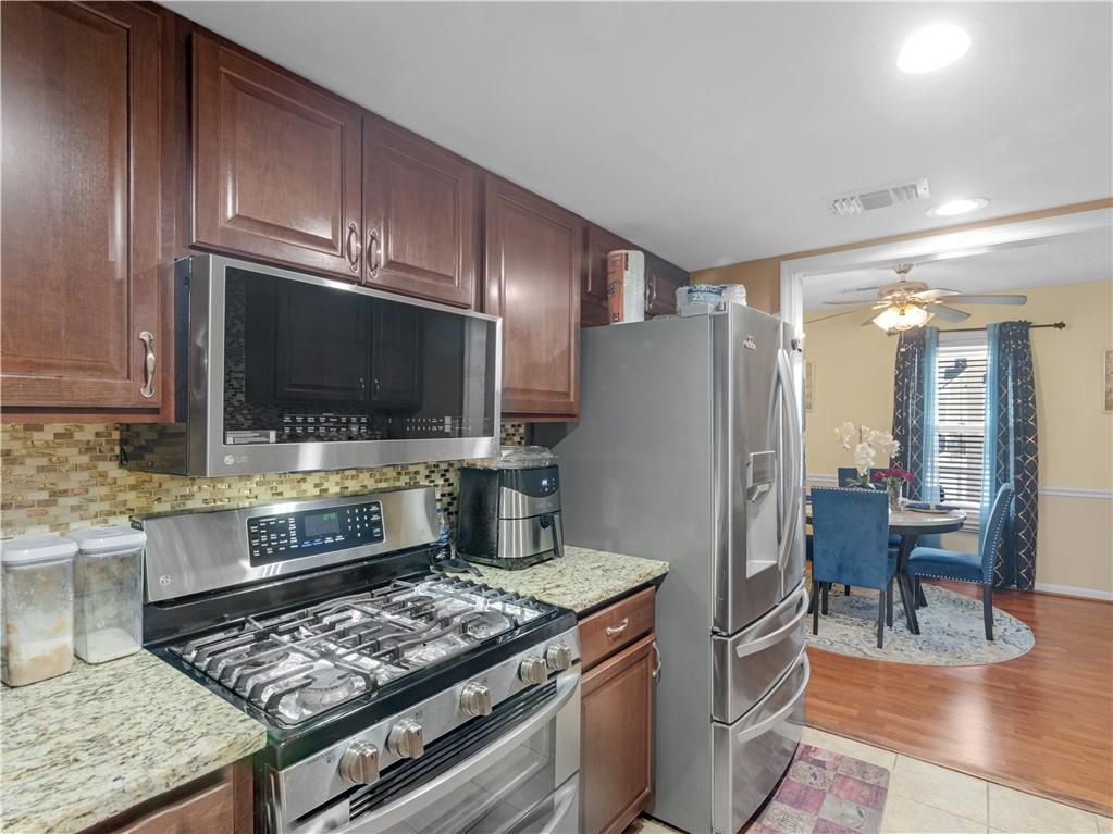 103 Oak Circle South Stockbridge, GA 30281 - Photo 5 of 11 a kitchen with stainless steel appliances granite countertop a stove refrigerator and cabinets