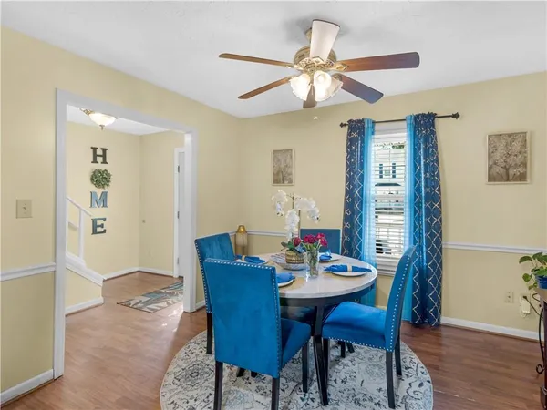 a view of a dining room with furniture window and wooden floor