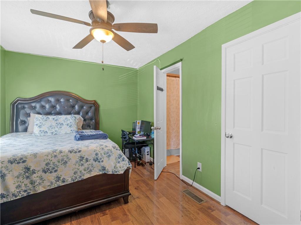 103 Oak Circle South Stockbridge, GA 30281 - Photo 8 of 11 a bedroom with a bed and a chandelier