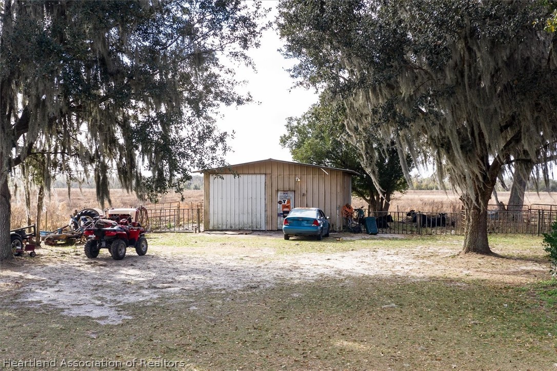 2364 County Line Road Bowling Green, FL 33834 - Photo 21 of 24 a view of a house with truck parked in front of a house