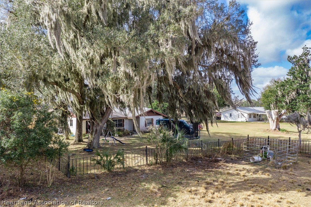 2364 County Line Road Bowling Green, FL 33834 - Photo 22 of 24 a view of a yard with plants and trees
