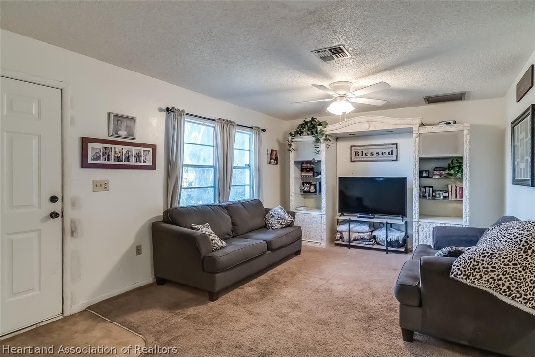 2364 County Line Road Bowling Green, FL 33834 - Photo 4 of 24 a living room with furniture and a flat screen tv