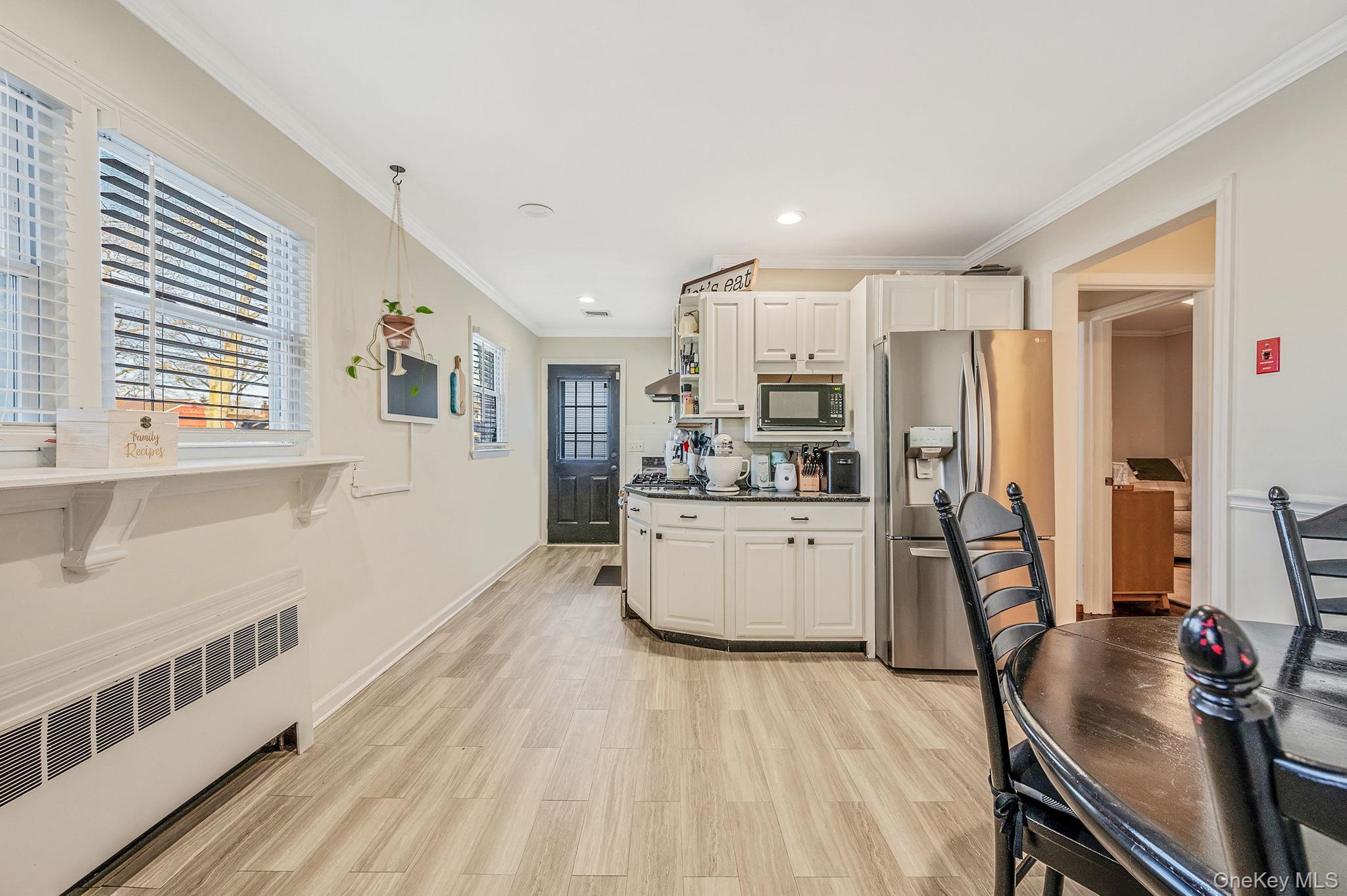 792 Frankford Road West Babylon, NY 11704 - Photo 12 of 39 a kitchen with stainless steel appliances a refrigerator and wooden floor