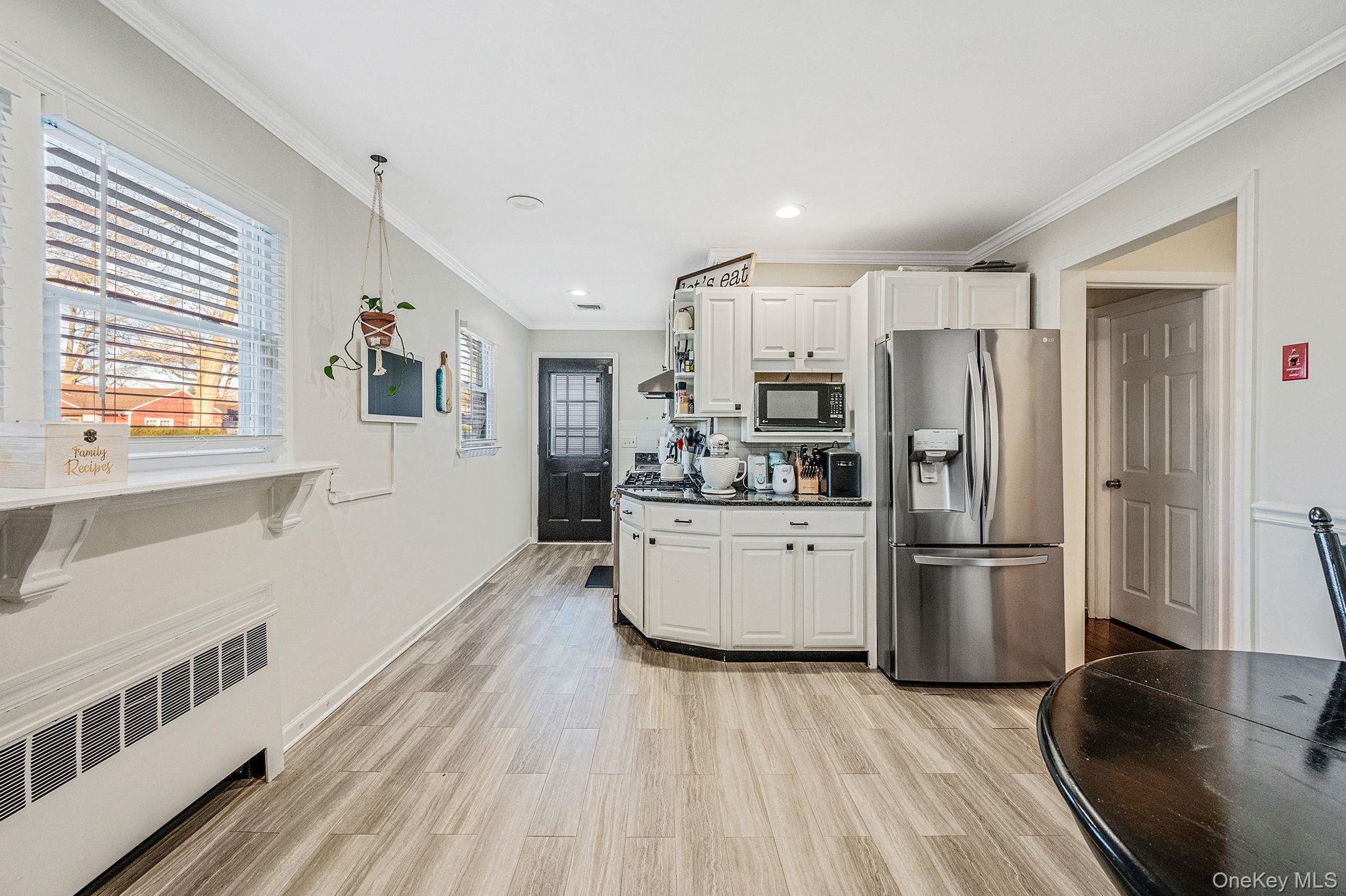 792 Frankford Road West Babylon, NY 11704 - Photo 13 of 39 a kitchen with a refrigerator and a stove top oven