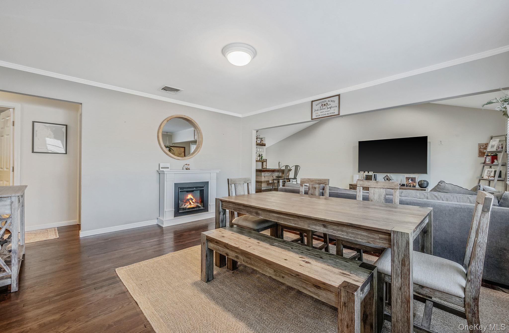 792 Frankford Road West Babylon, NY 11704 - Photo 2 of 39 a living room with furniture a flat screen tv and a fireplace