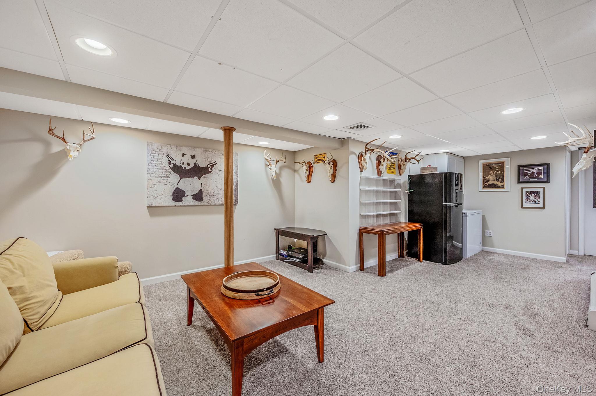 792 Frankford Road West Babylon, NY 11704 - Photo 31 of 39 a living room with furniture and a flat screen tv
