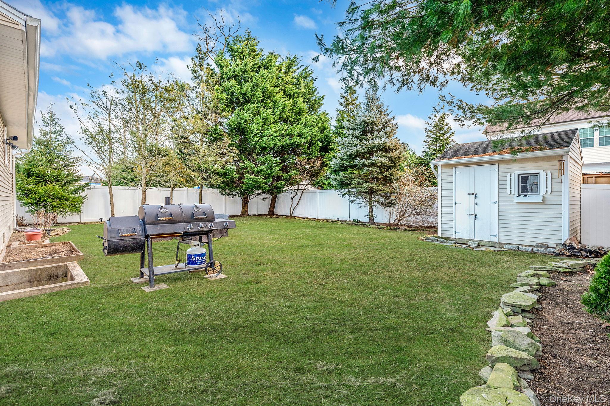 792 Frankford Road West Babylon, NY 11704 - Photo 39 of 39 a garden with trees and wooden fence