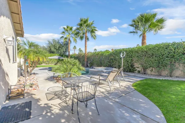 a view of a backyard with a garden and swimming pool