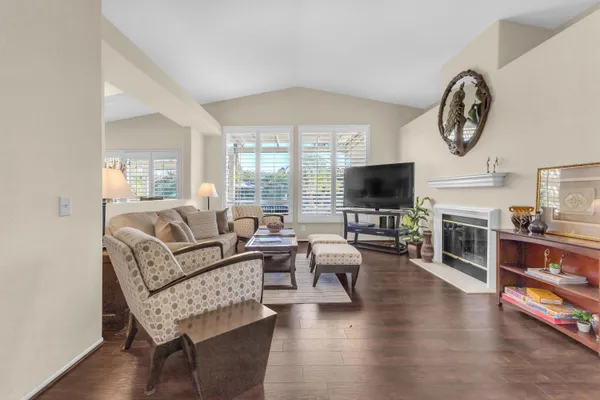 a living room with fireplace furniture and a flat screen tv