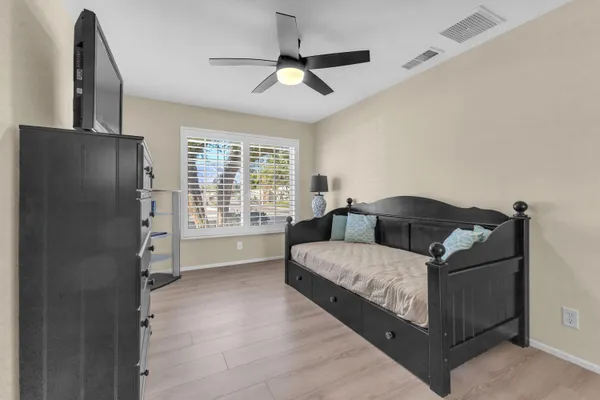 a living room with a bed furniture and a window