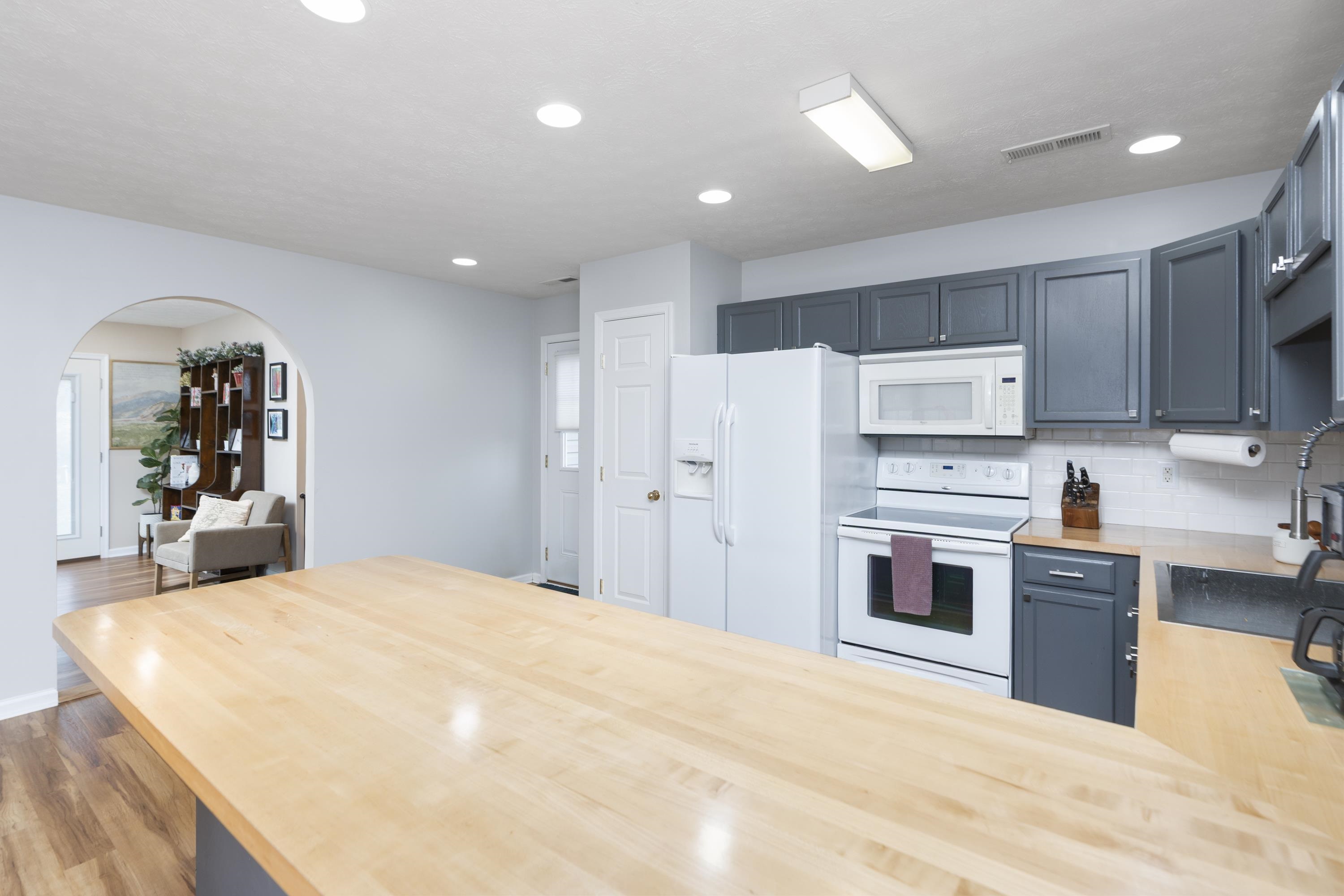 331 Stone Branch Road Staunton, VA 24401 - Photo 15 of 75 a large white kitchen with kitchen island a sink a stove and refrigerator