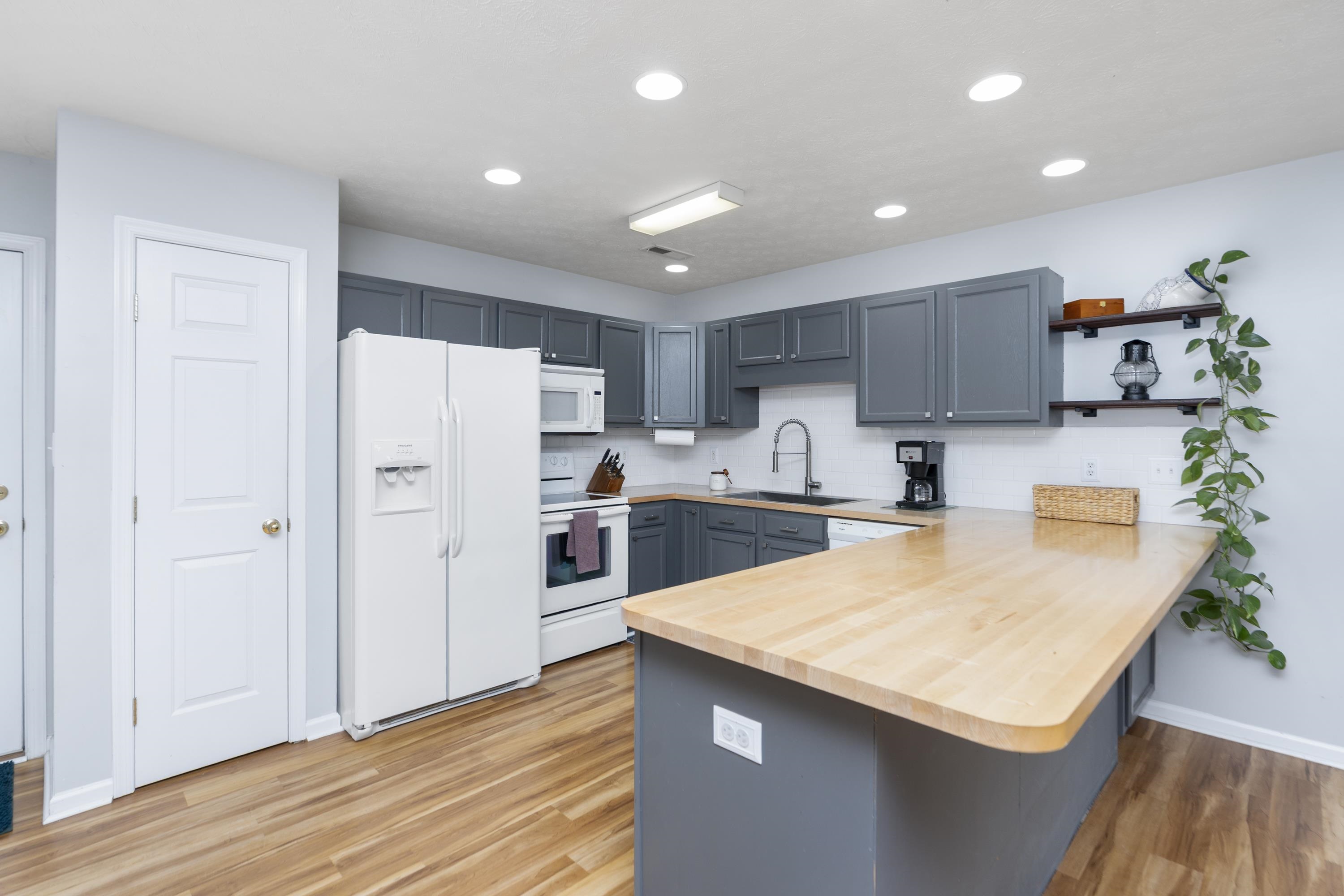 331 Stone Branch Road Staunton, VA 24401 - Photo 2 of 75 a kitchen with a sink a refrigerator and a stove top oven