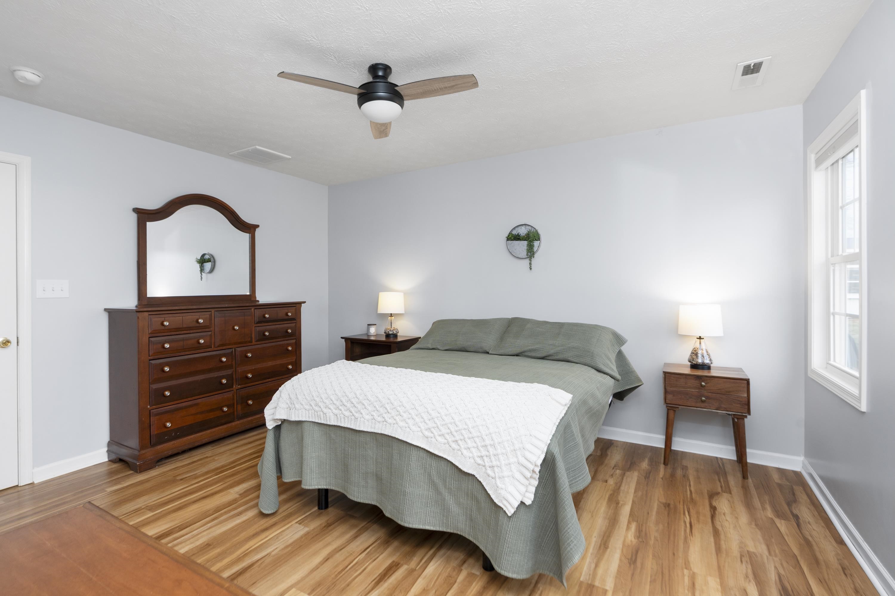 331 Stone Branch Road Staunton, VA 24401 - Photo 9 of 75 a bedroom with a bed and a dresser with wooden floor