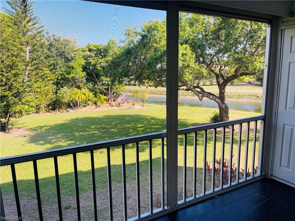 5499 Rattlesnake Hammock Road, Unit A207 Naples, FL 34113 - Photo 13 of 31 Lanai with View of Canal, Golf Course andPeaceful Landscaped Area