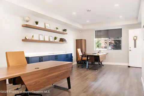 a view of a room that has a table and chairs in it