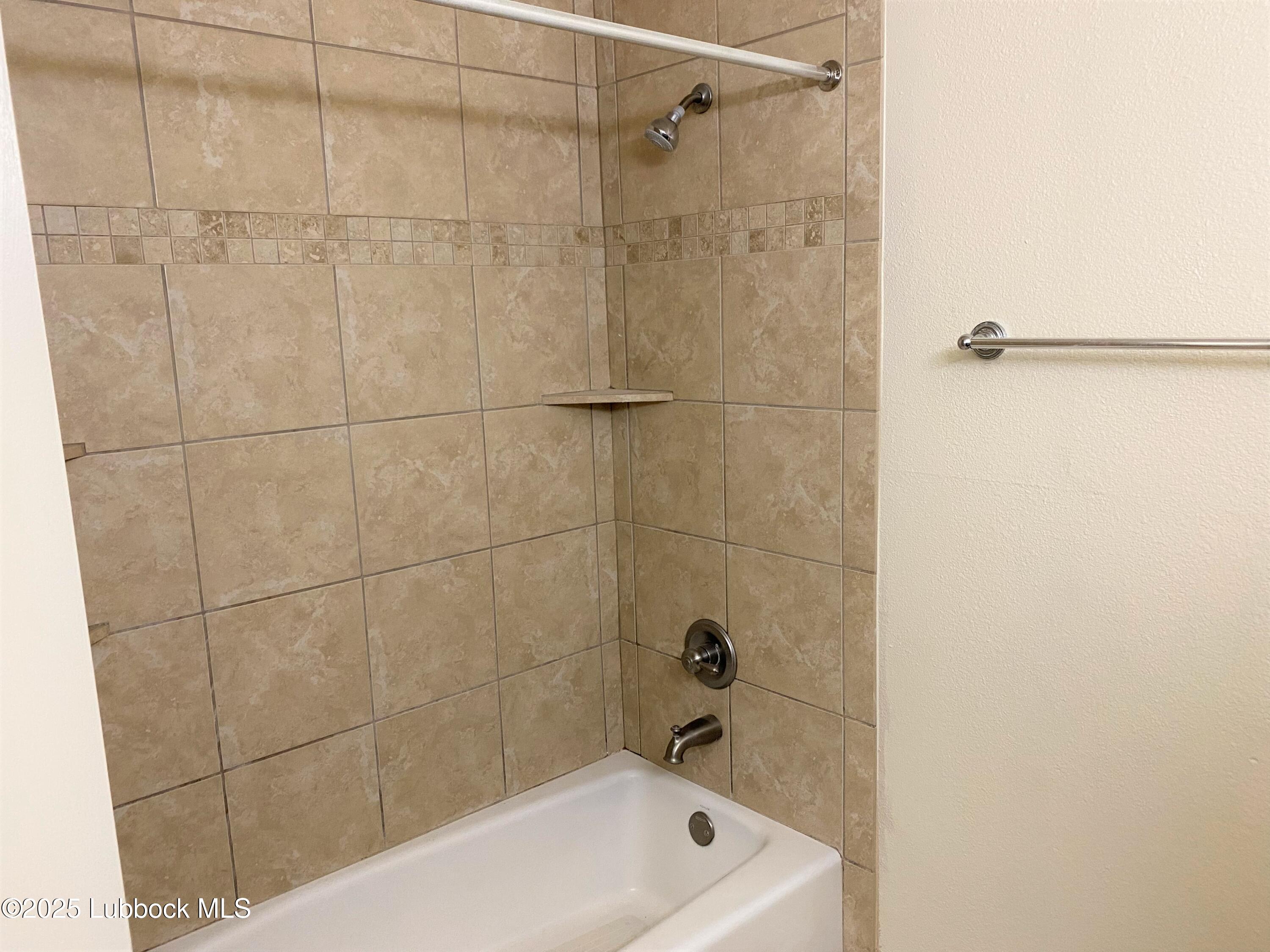 5207 39th Street Lubbock, TX 79414 - Photo 15 of 20 a bathroom with a bathtub
