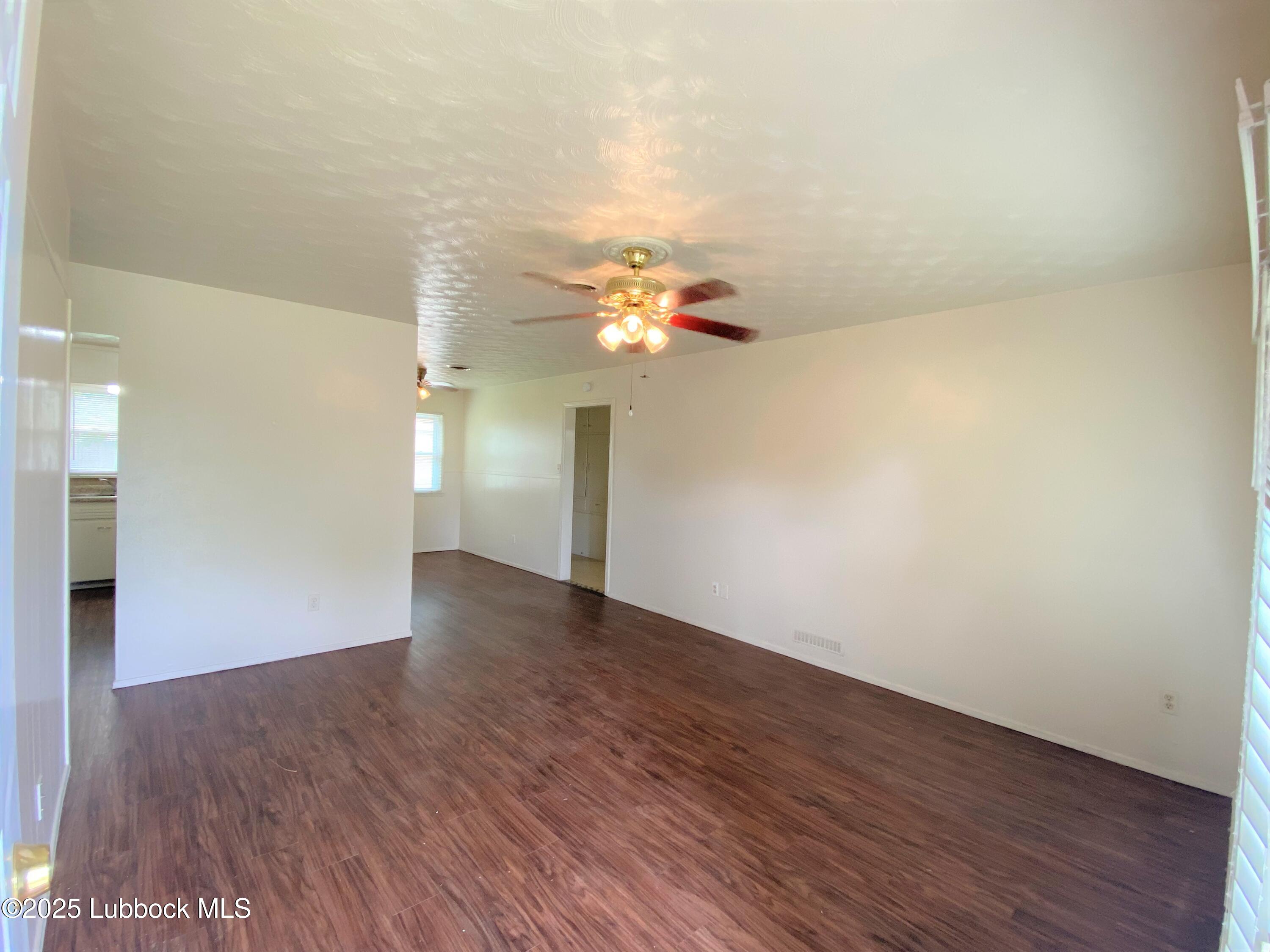 5207 39th Street Lubbock, TX 79414 - Photo 2 of 20 a view of an empty room with wooden floor