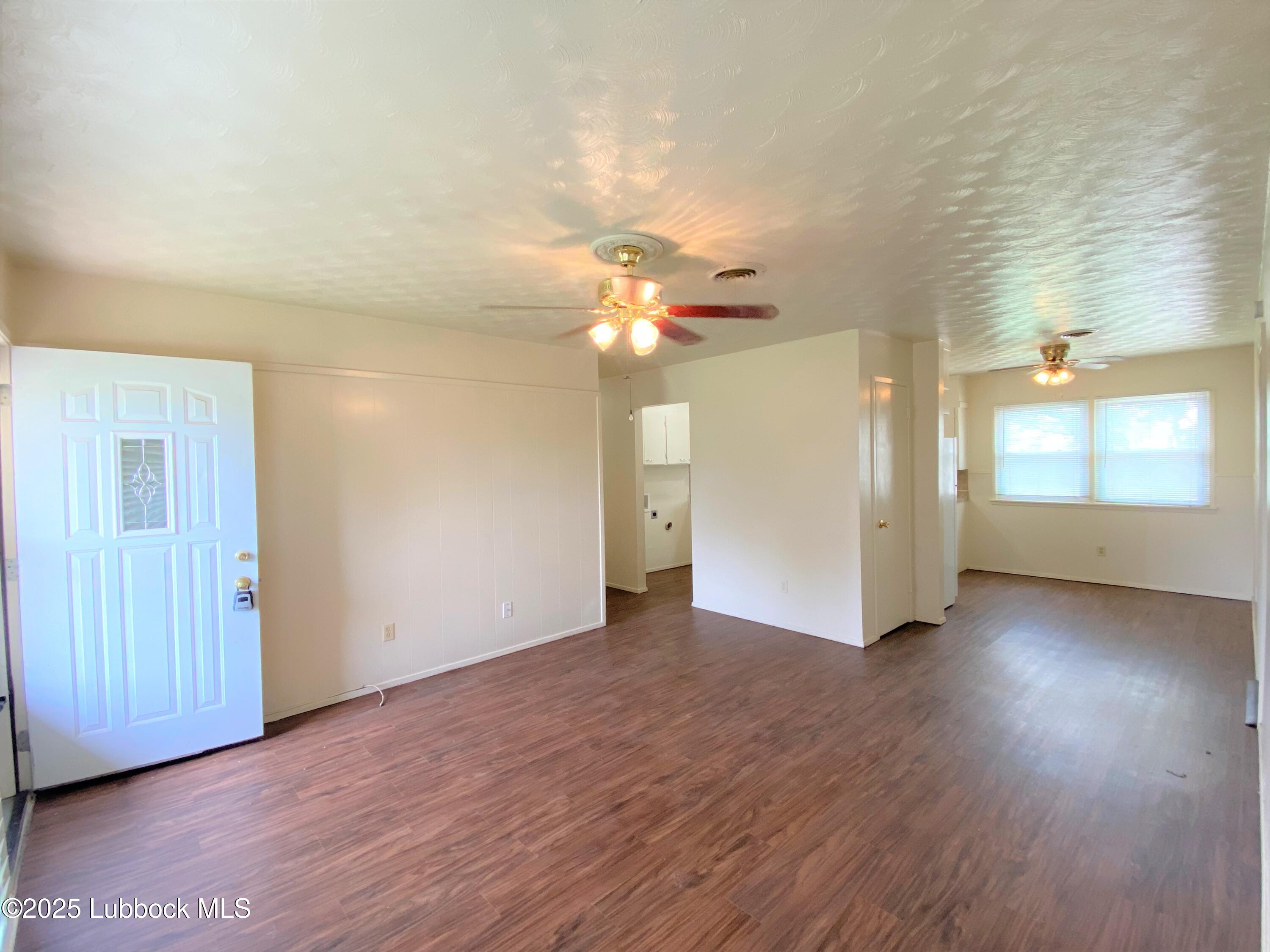 5207 39th Street Lubbock, TX 79414 - Photo 3 of 20 wooden floor in an empty room with a window