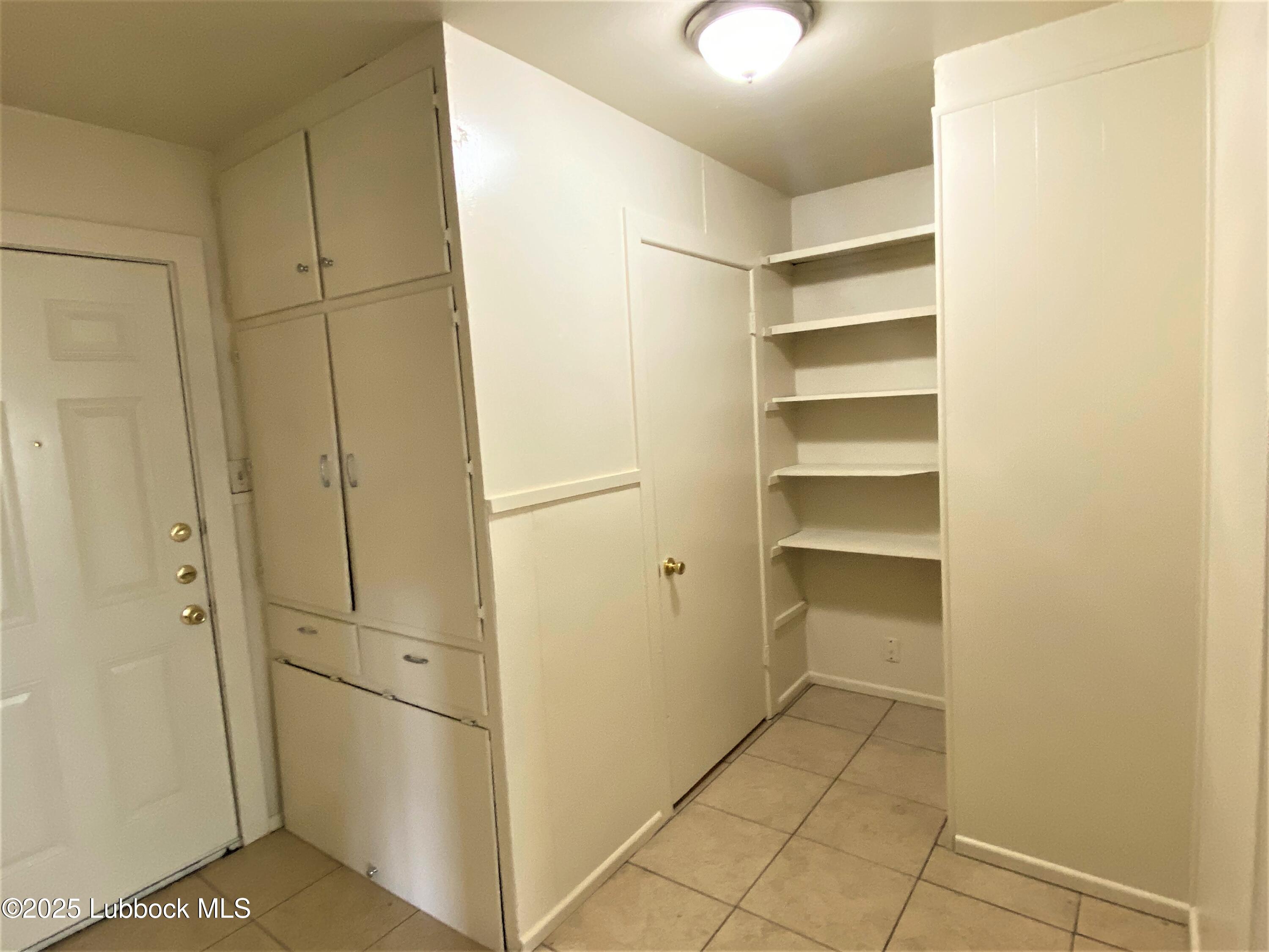 5207 39th Street Lubbock, TX 79414 - Photo 5 of 20 a view of walk in closet with empty racks