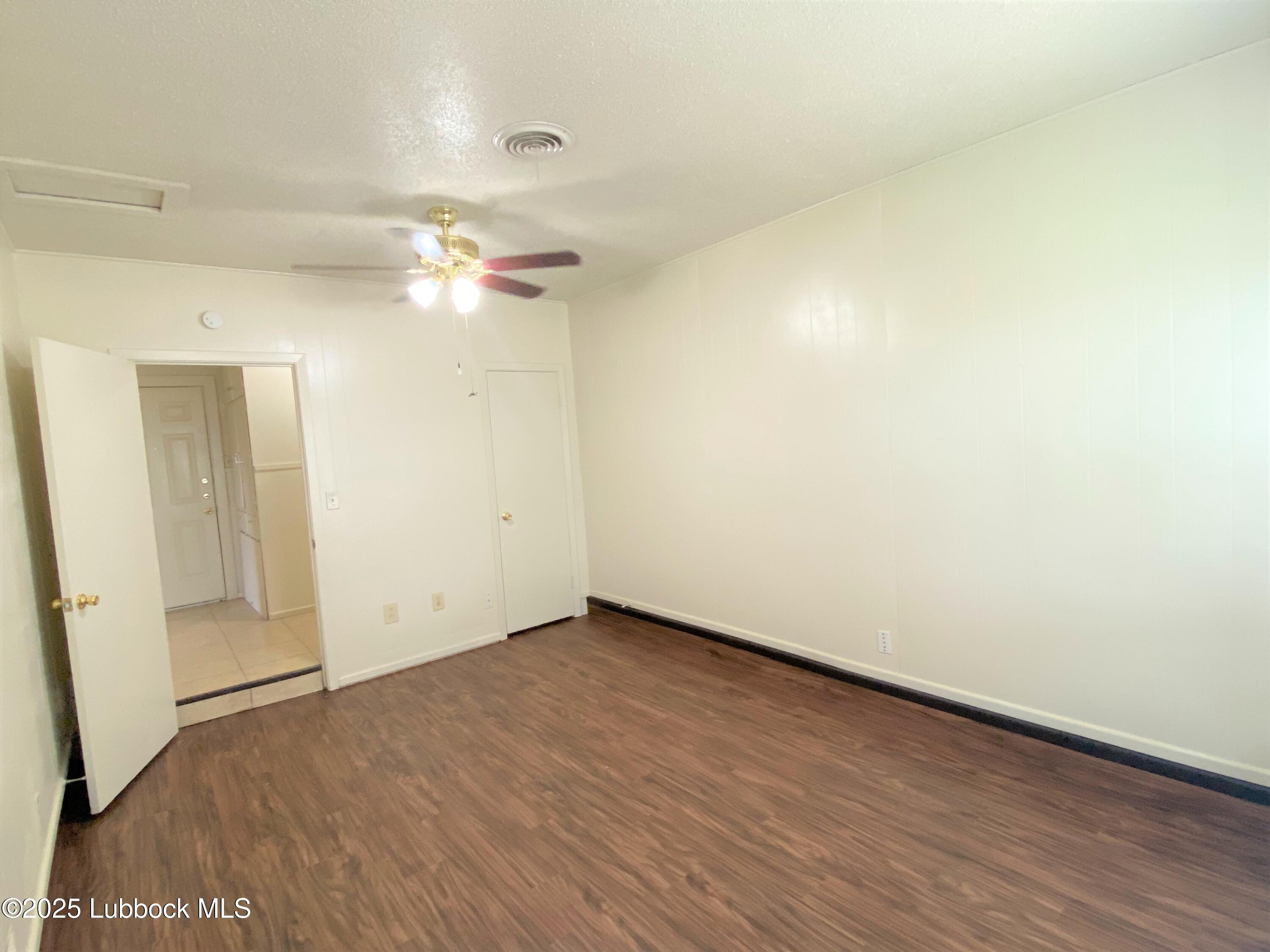 5207 39th Street Lubbock, TX 79414 - Photo 7 of 20 a view of an empty room with chandelier fan and a window