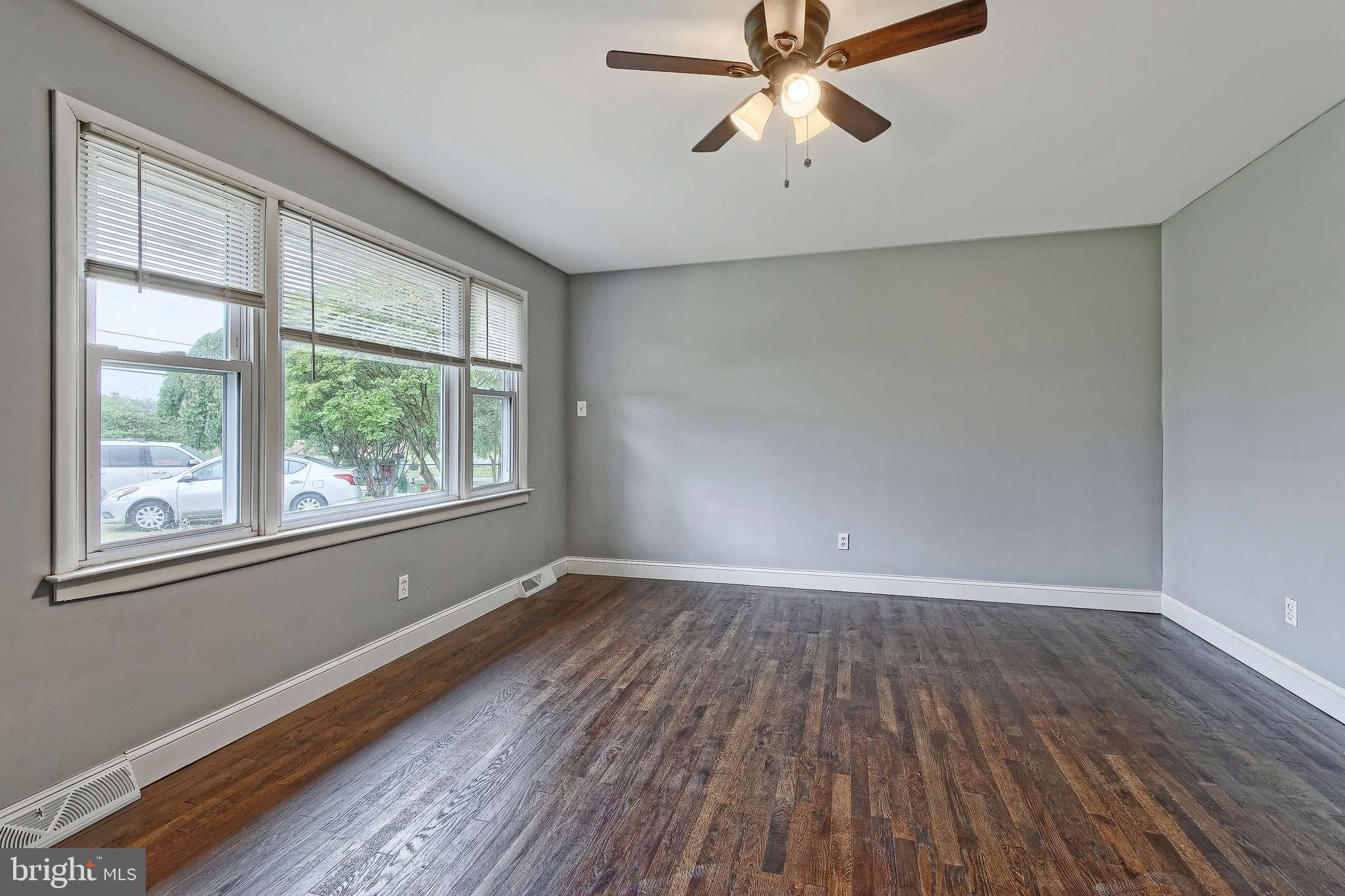 3176 Hance Bridge Road Vineland, NJ 08361 - Photo 12 of 24 an empty room with wooden floor fan and windows