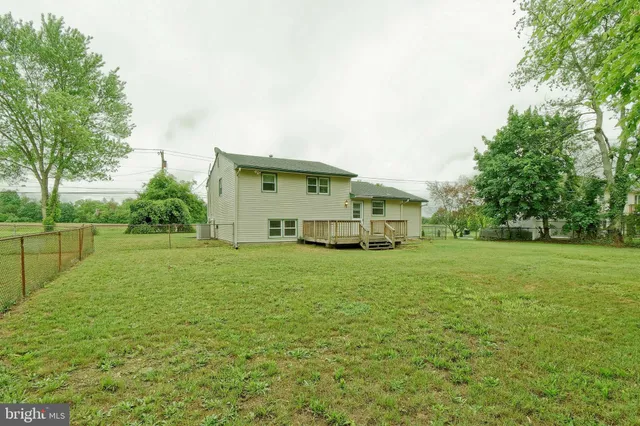 a yellow house with garden in front of it