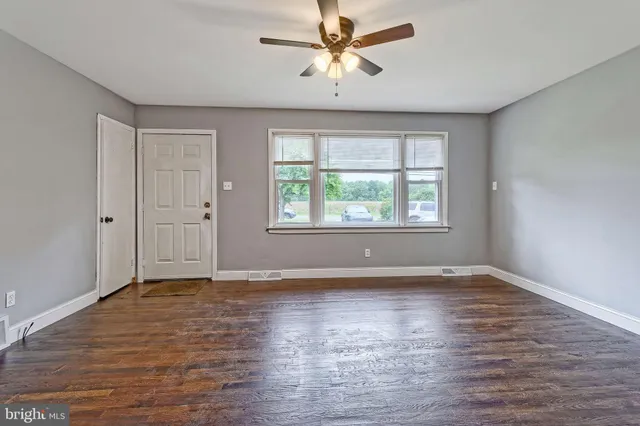 wooden floor in an empty room with a window