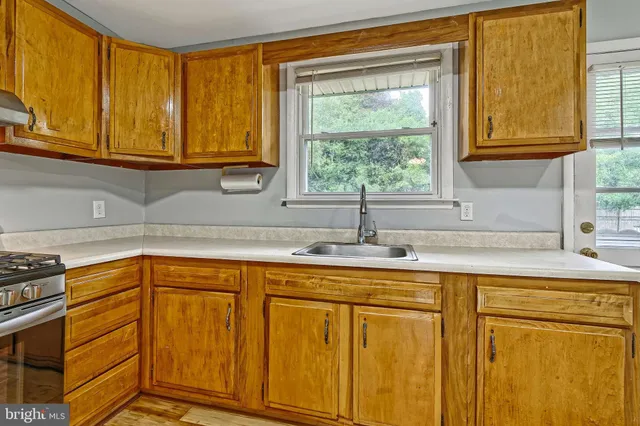 a kitchen with stainless steel appliances granite countertop a sink and cabinets