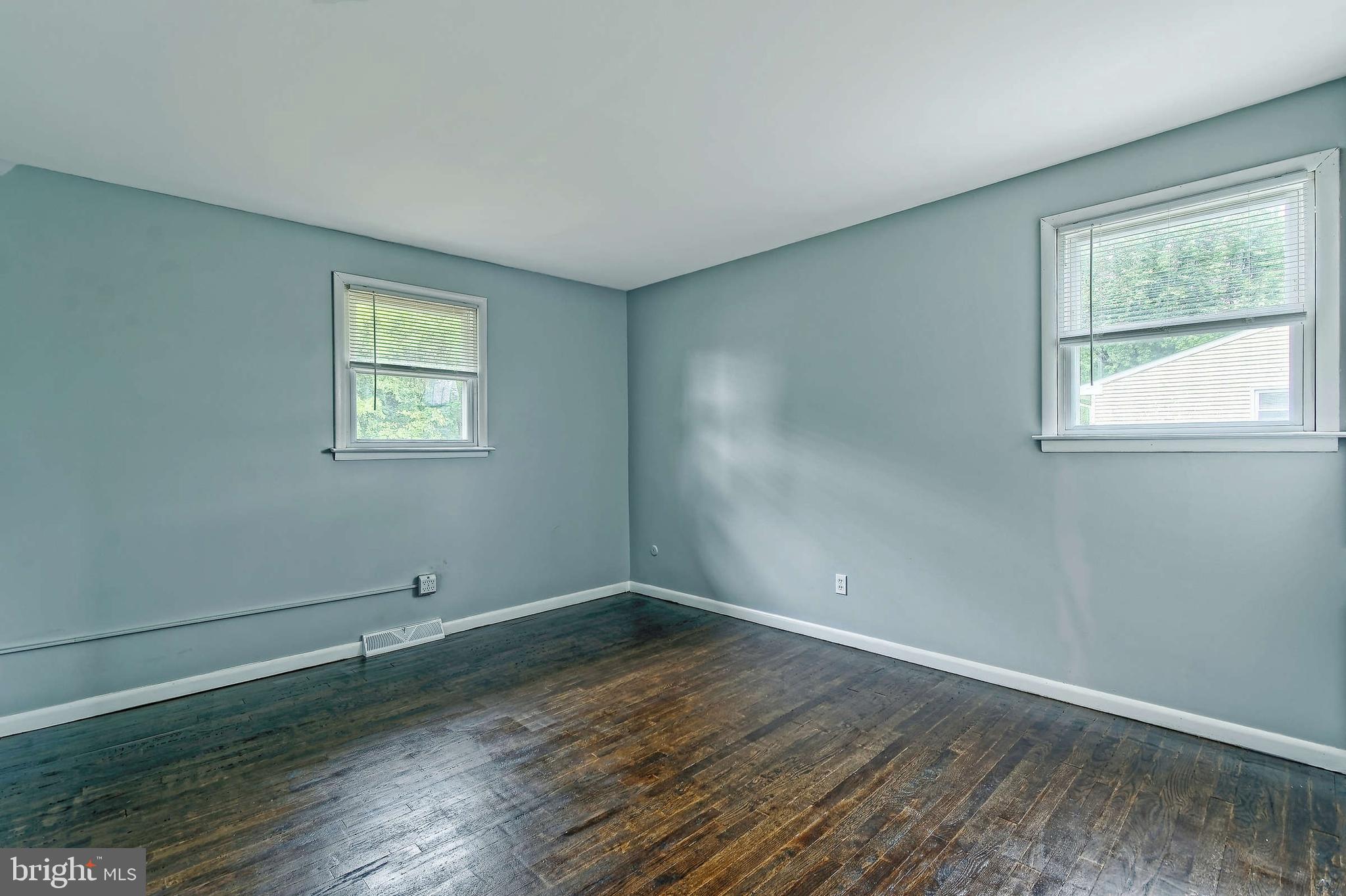 3176 Hance Bridge Road Vineland, NJ 08361 - Photo 8 of 24 an empty room with wooden floor and windows