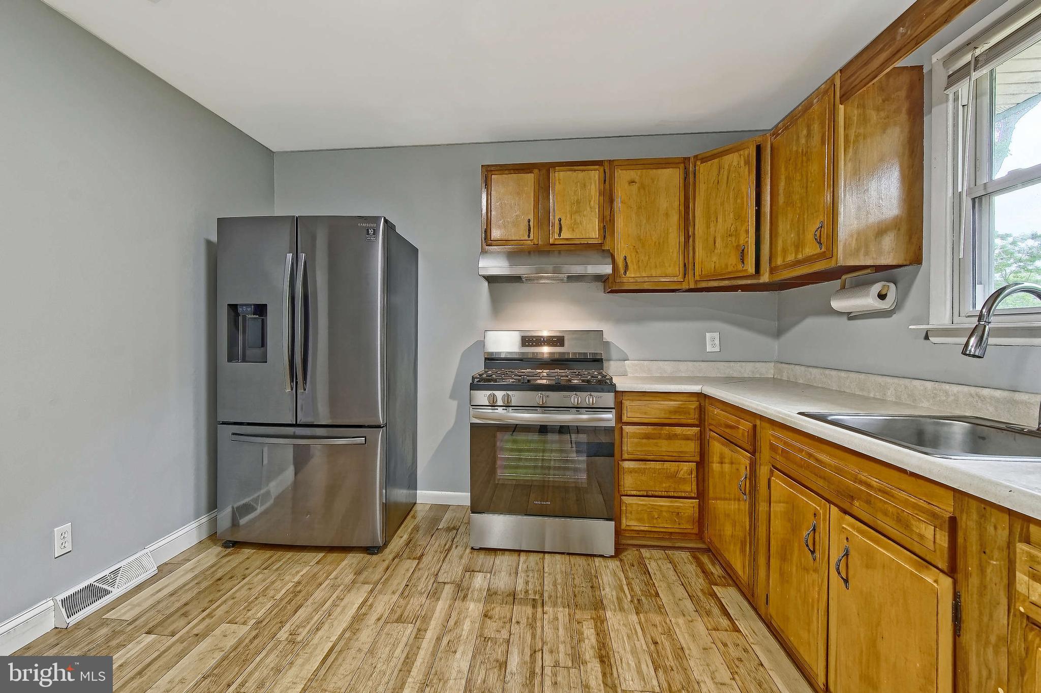3176 Hance Bridge Road Vineland, NJ 08361 - Photo 9 of 24 a kitchen with a refrigerator wooden floor and a sink