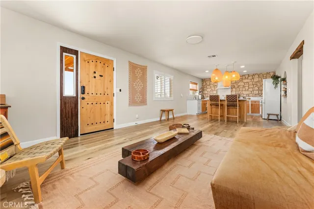 a large kitchen with cabinets and a wooden floor