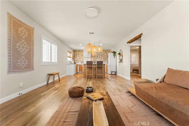a living room with furniture window and wooden floor