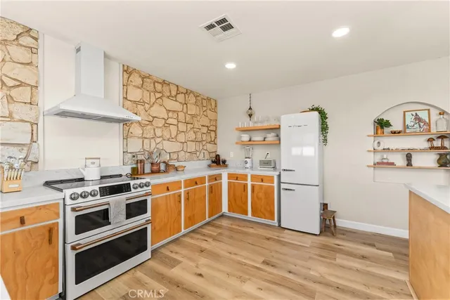 a bathroom with a granite countertop toilet a mirror and a sink