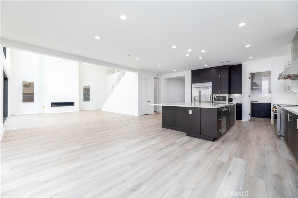 108 Coldwater Irvine, CA 92602 - Photo 15 of 36 a large kitchen with stainless steel appliances granite countertop a large counter top a sink and a refrigerator