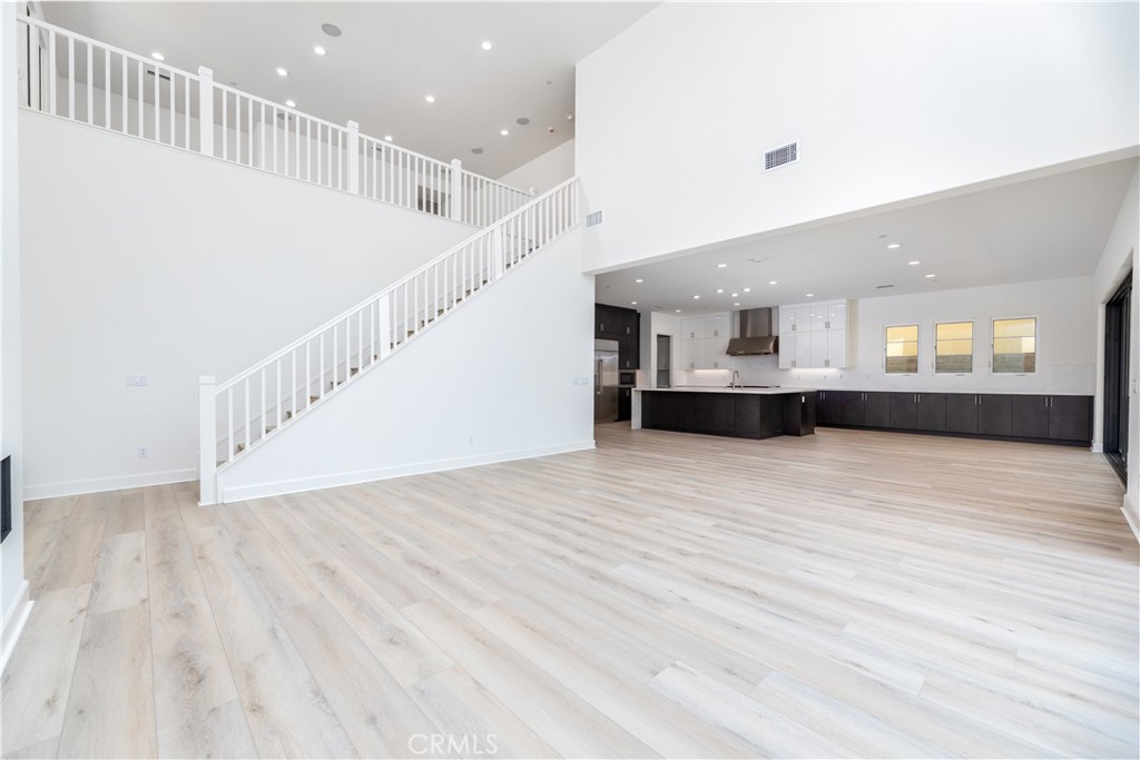 108 Coldwater Irvine, CA 92602 - Photo 23 of 36 a view of kitchen and hall with wooden floor